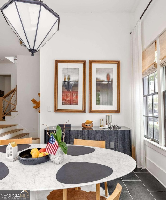 dining room with dark tile patterned floors