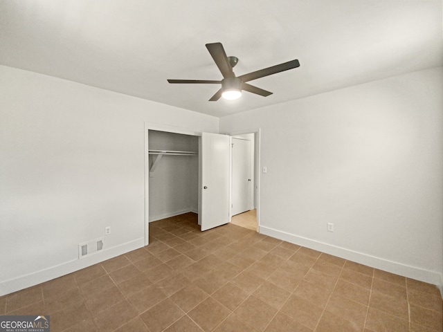 unfurnished bedroom with ceiling fan and a closet