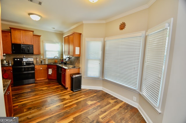 kitchen with decorative backsplash, stainless steel electric range oven, dark stone counters, dark wood-type flooring, and crown molding