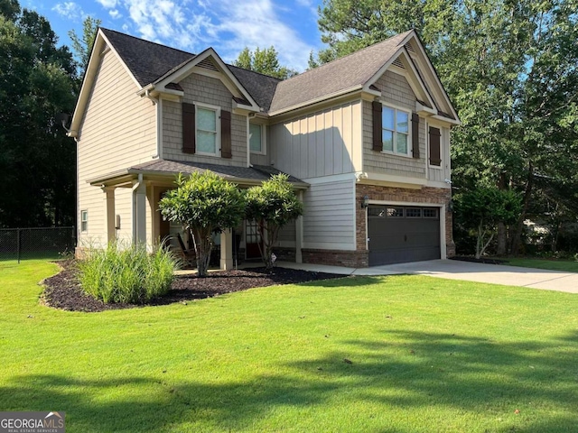 craftsman inspired home featuring a front yard and a garage