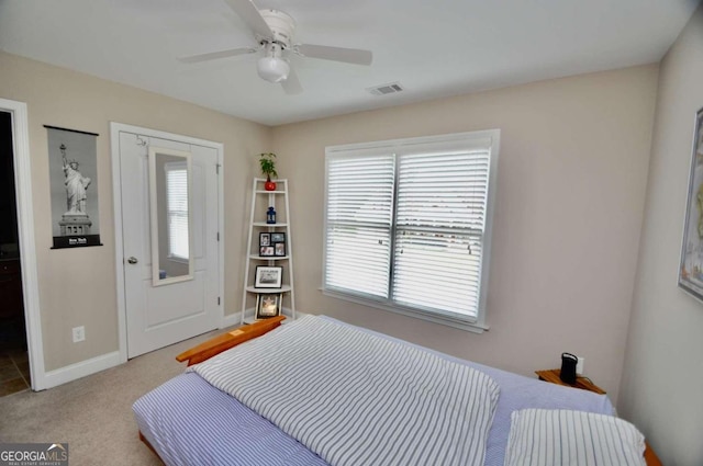 bedroom featuring light colored carpet and ceiling fan