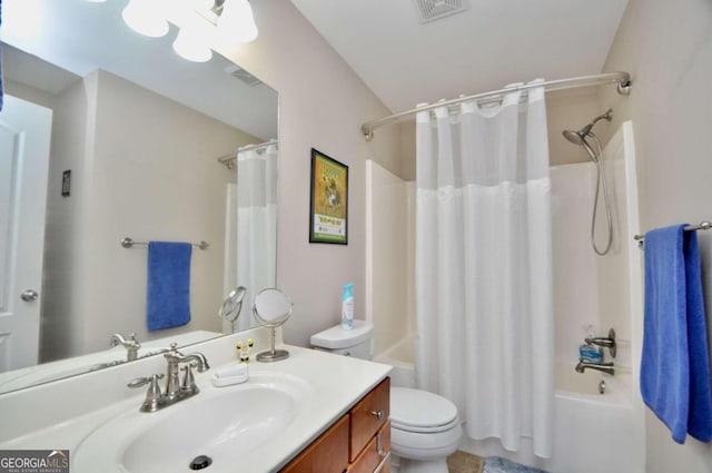 full bathroom with toilet, vanity, and shower / tub combo