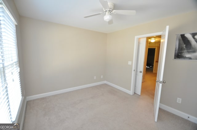 unfurnished room with light carpet and ceiling fan