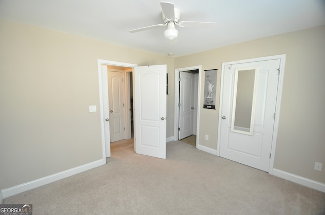 unfurnished bedroom with ceiling fan and light colored carpet