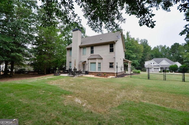 rear view of property featuring a patio area and a lawn