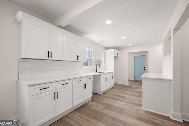 kitchen featuring sink, white cabinets, and light hardwood / wood-style floors