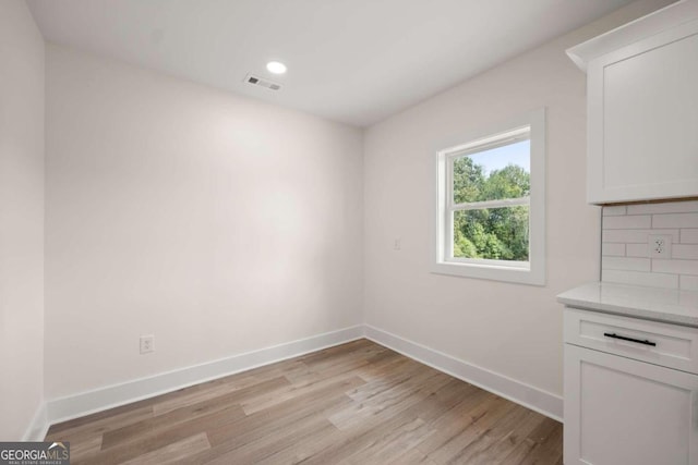 unfurnished dining area with light hardwood / wood-style floors