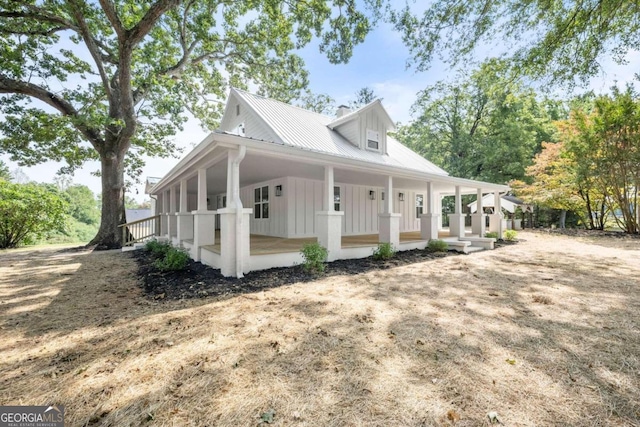 view of side of property with a porch