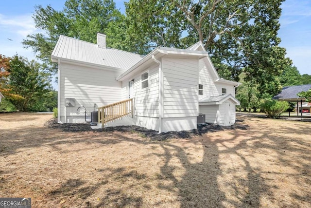 rear view of property featuring central air condition unit