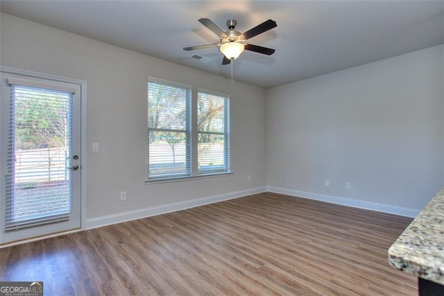 interior space with ceiling fan and hardwood / wood-style flooring