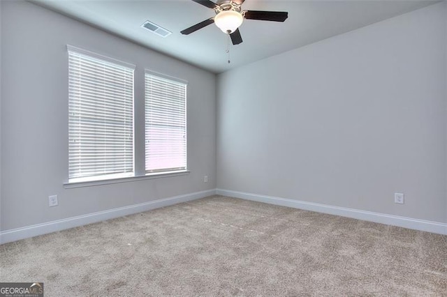 unfurnished room with ceiling fan and light colored carpet