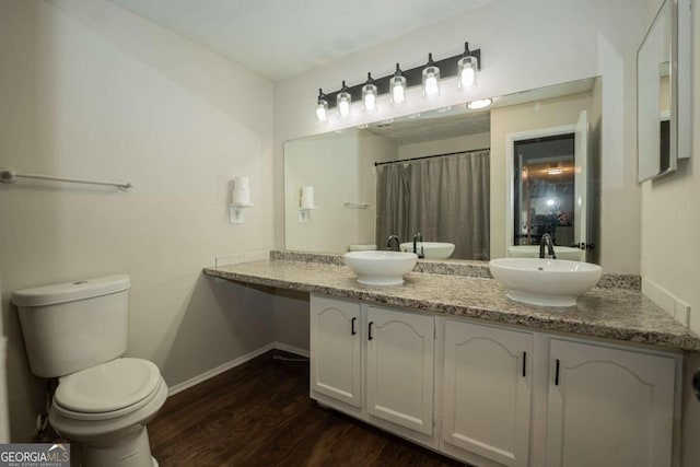 bathroom featuring vanity, hardwood / wood-style floors, and toilet