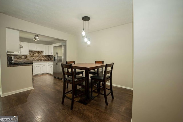 dining room with dark hardwood / wood-style flooring