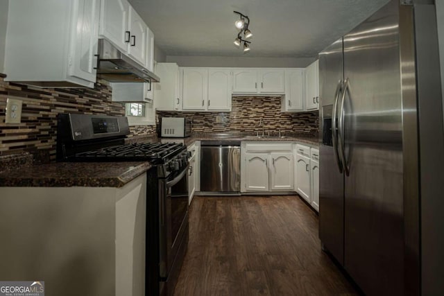 kitchen with tasteful backsplash, sink, white cabinetry, stainless steel appliances, and dark hardwood / wood-style flooring