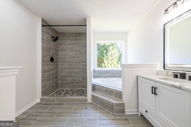 bathroom featuring vanity and plus walk in shower