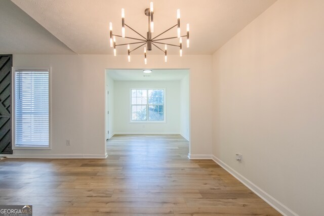 interior space featuring an inviting chandelier and light hardwood / wood-style floors