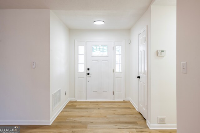 foyer with light hardwood / wood-style floors