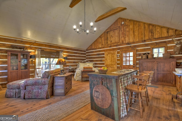 interior space featuring beamed ceiling, wood walls, a notable chandelier, light wood-type flooring, and high vaulted ceiling