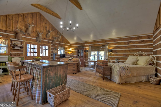 kitchen with beam ceiling, high vaulted ceiling, an inviting chandelier, and light hardwood / wood-style floors