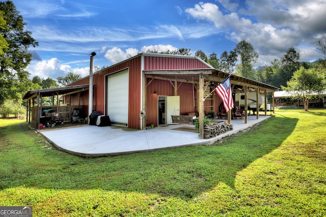 exterior space with a garage, a lawn, and an outdoor structure