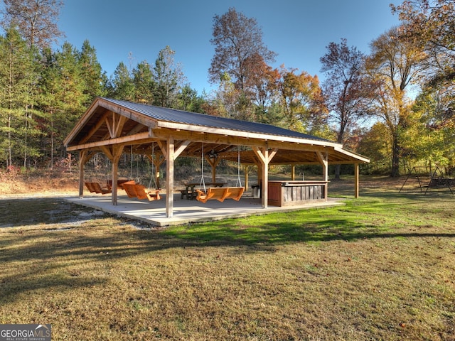 surrounding community with a lawn and a patio