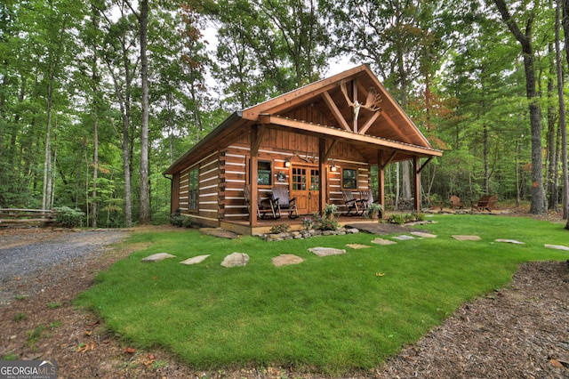 log-style house featuring a front yard and a porch