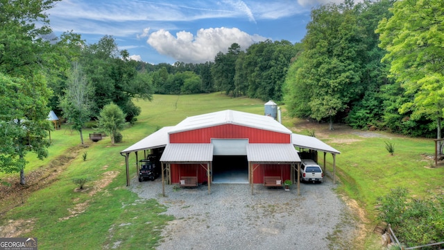 exterior space with a carport, a yard, and a garage