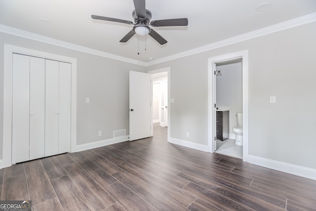 unfurnished bedroom with a closet, ceiling fan, dark hardwood / wood-style floors, and ensuite bath