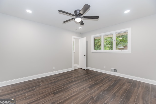 empty room featuring dark wood-type flooring and ceiling fan