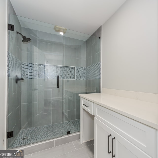 bathroom with a shower with door and vanity