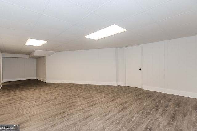 basement featuring hardwood / wood-style flooring and a paneled ceiling