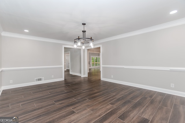 unfurnished room featuring dark hardwood / wood-style floors, an inviting chandelier, and crown molding