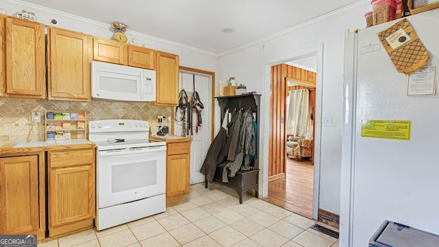 kitchen featuring light tile patterned floors, ornamental molding, white appliances, and decorative backsplash