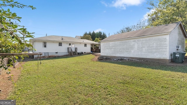 rear view of property with a lawn