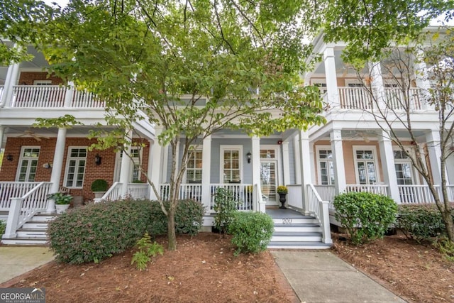 view of front facade with a balcony and covered porch