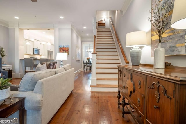 living room featuring crown molding and wood-type flooring