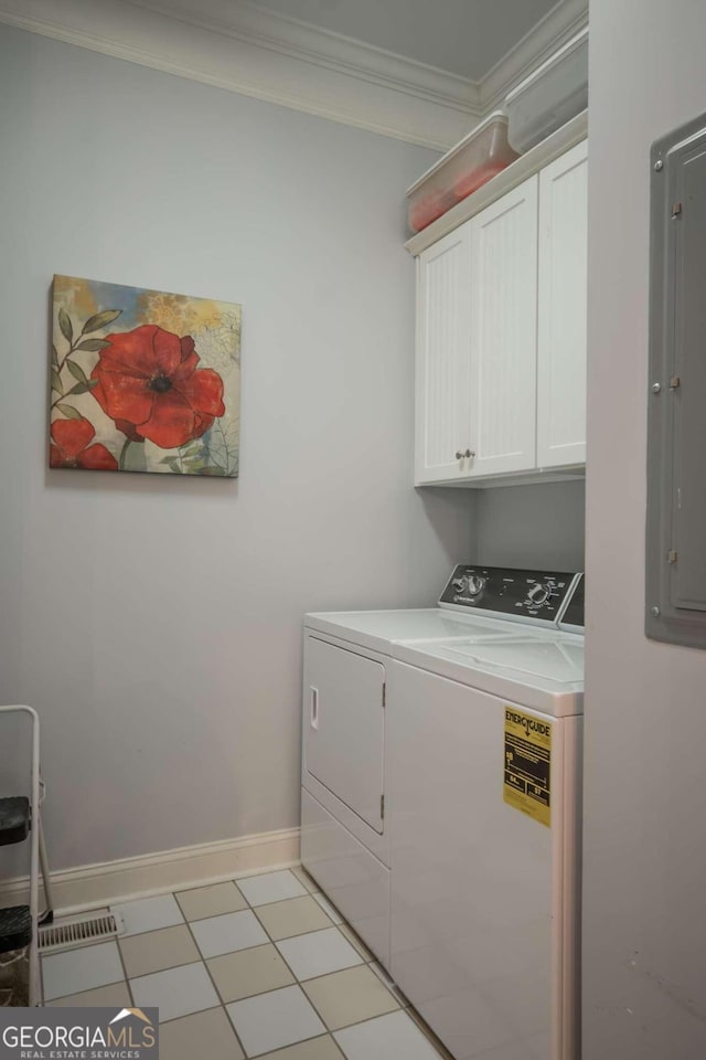 clothes washing area featuring cabinets, washer and clothes dryer, ornamental molding, light tile patterned floors, and electric panel