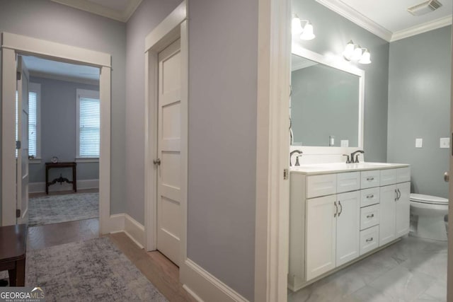 bathroom featuring crown molding, vanity, toilet, and hardwood / wood-style flooring