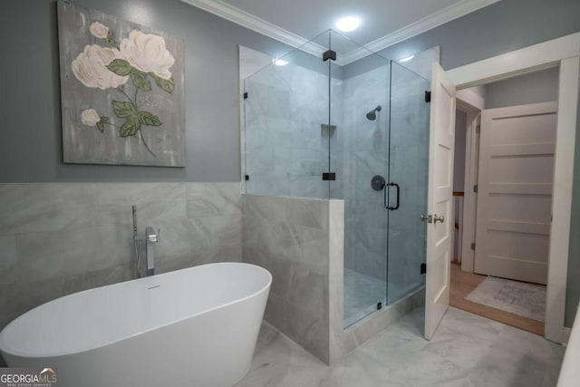 bathroom featuring plus walk in shower, tile walls, and crown molding