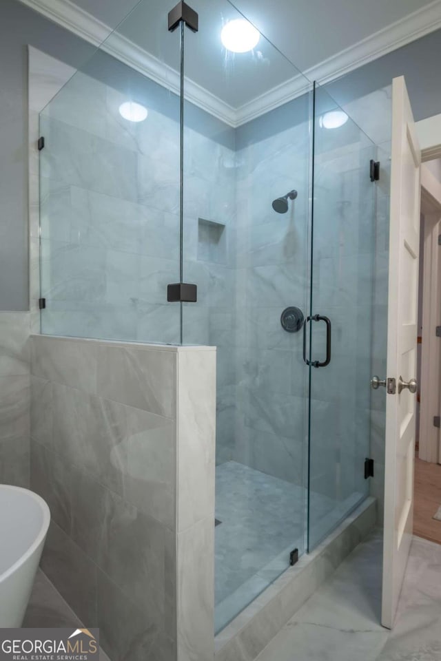 bathroom featuring crown molding and independent shower and bath