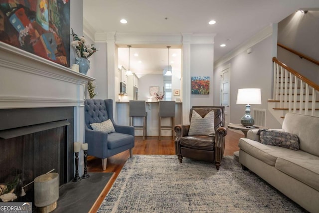 living room with dark wood-type flooring and crown molding