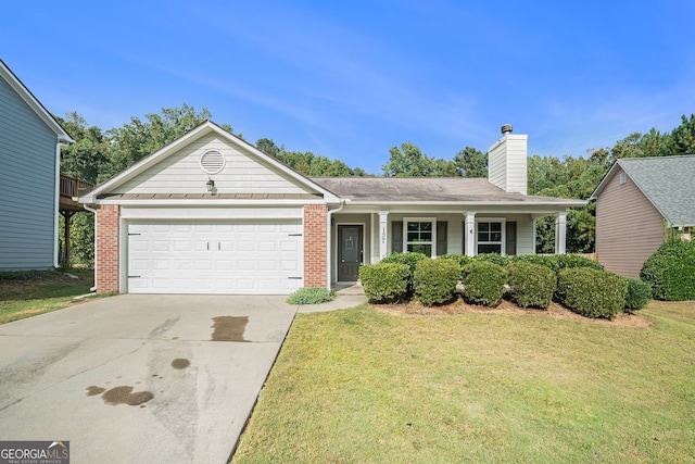 view of front of home with a garage and a front lawn