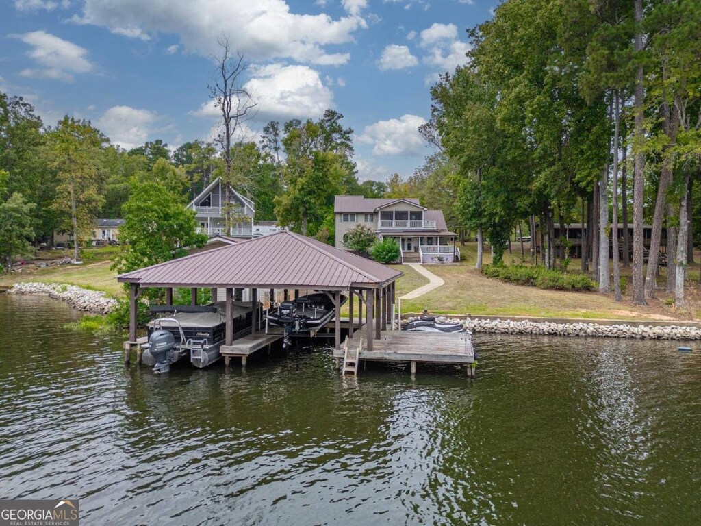 dock area with a yard and a water view