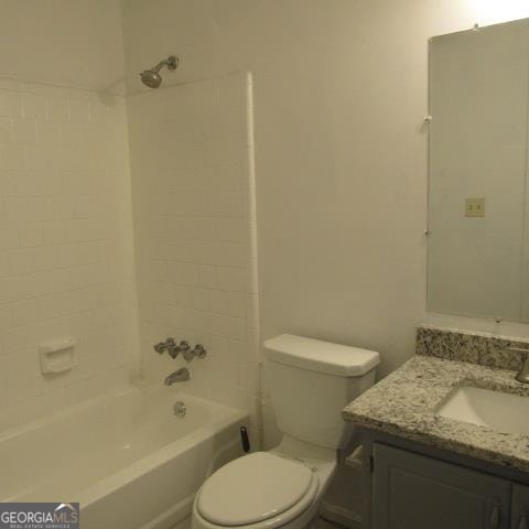 full bathroom featuring tiled shower / bath, toilet, and vanity