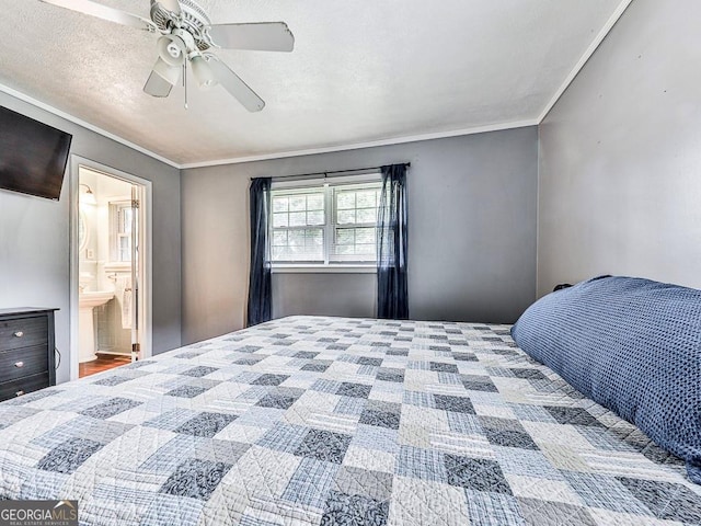 bedroom with a textured ceiling, crown molding, ensuite bath, and ceiling fan