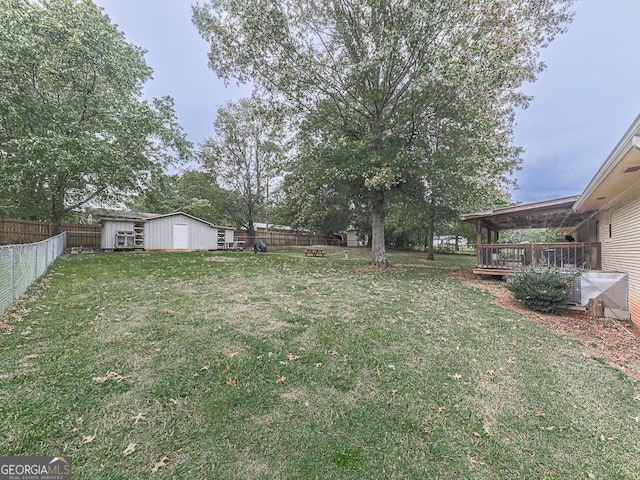 view of yard with a storage unit and a wooden deck