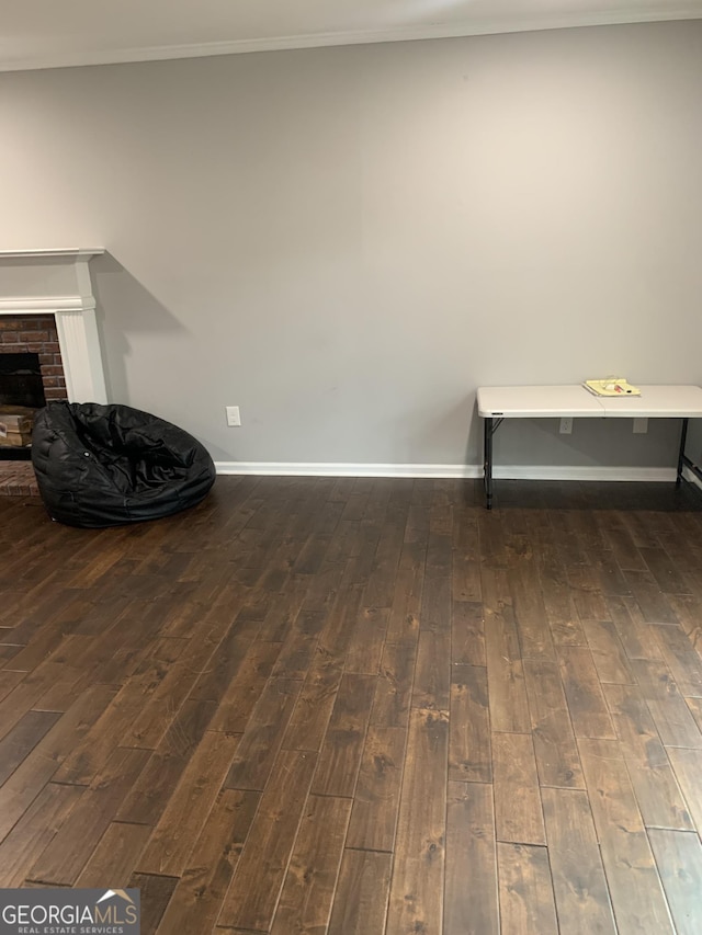 interior space with hardwood / wood-style floors and a brick fireplace