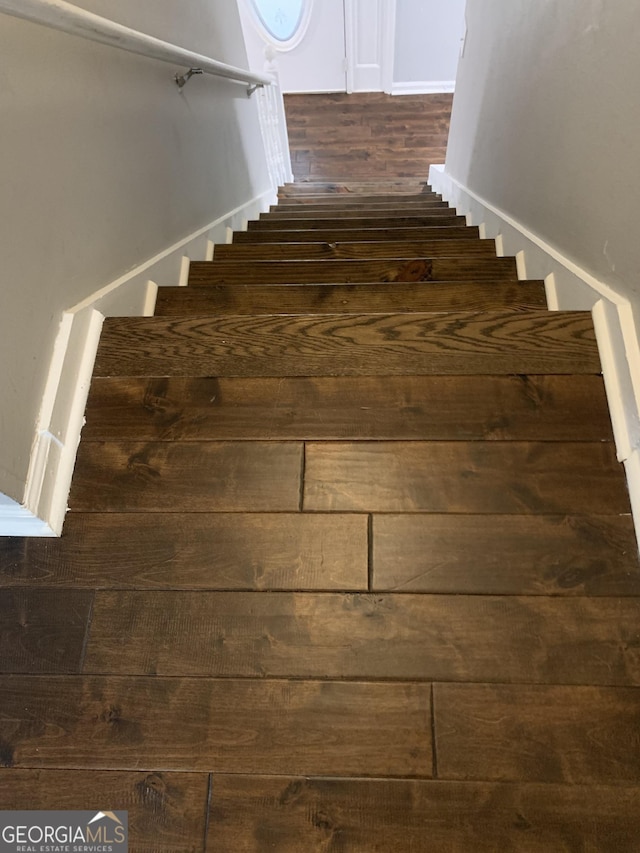 staircase featuring hardwood / wood-style floors