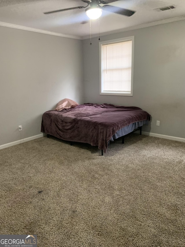 carpeted bedroom with ceiling fan and crown molding