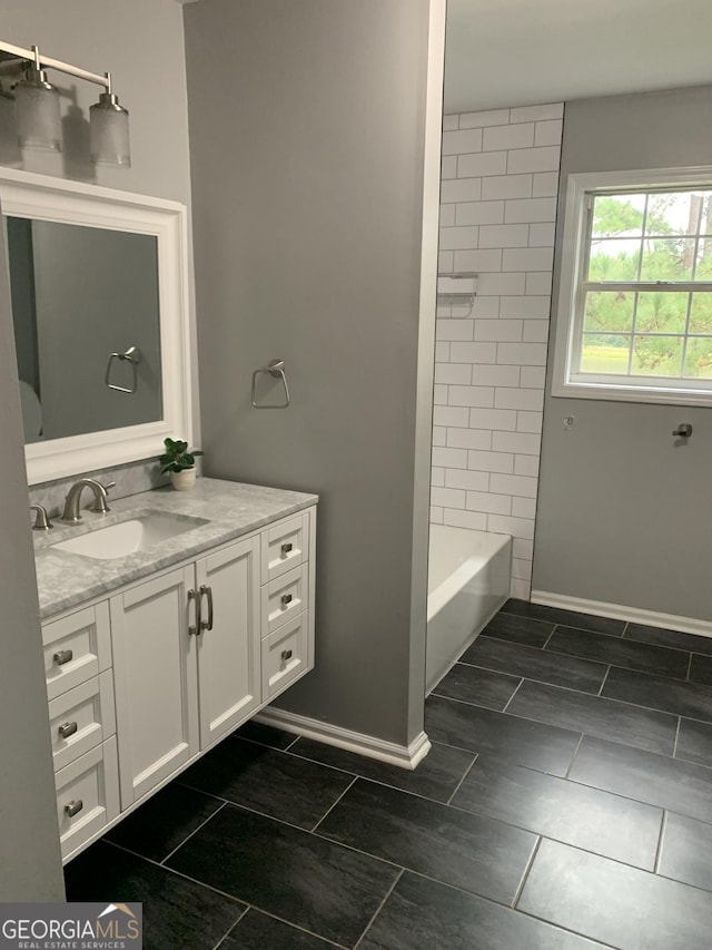 bathroom featuring vanity and tiled shower / bath combo